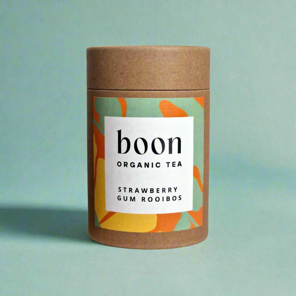 Boon Organic Tea container strawberry gum rooibos organic tea with colorful label on a green background